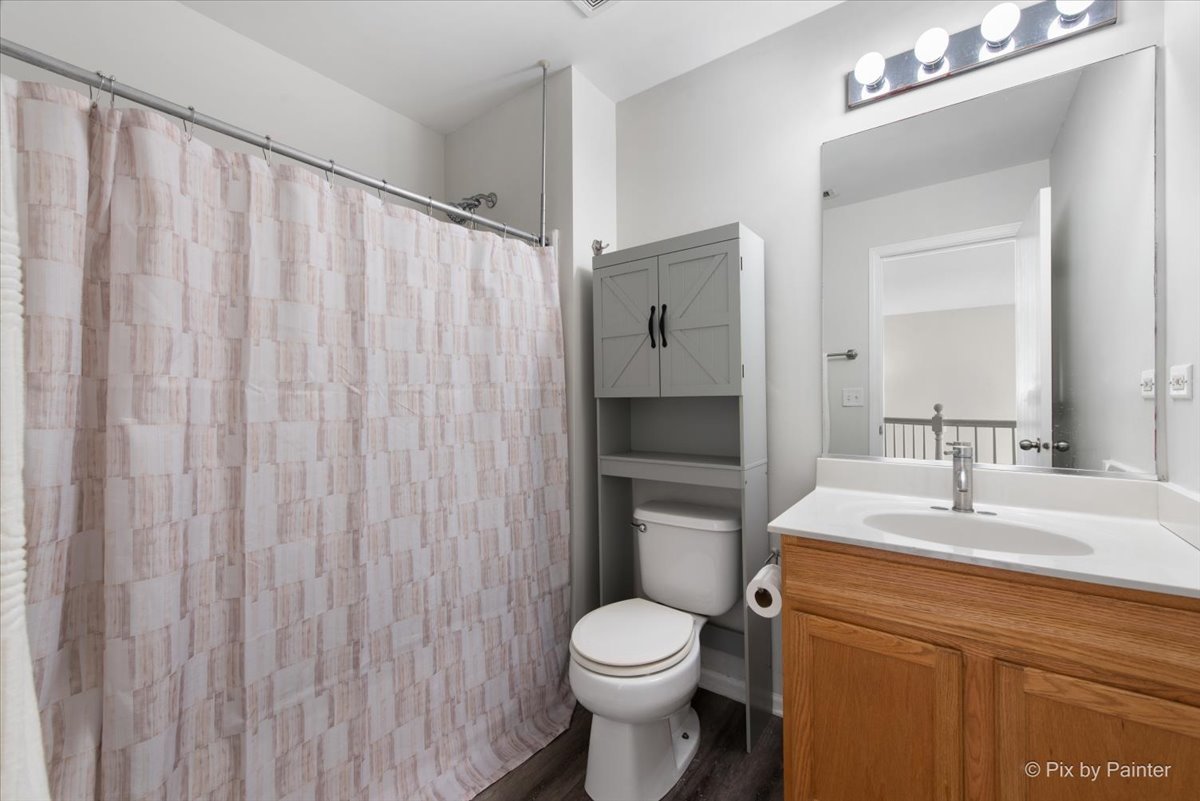 1033 Key Largo Drive Romeoville, IL 60446 - Photo 20 of 30 a bathroom with a toilet a sink and a mirror