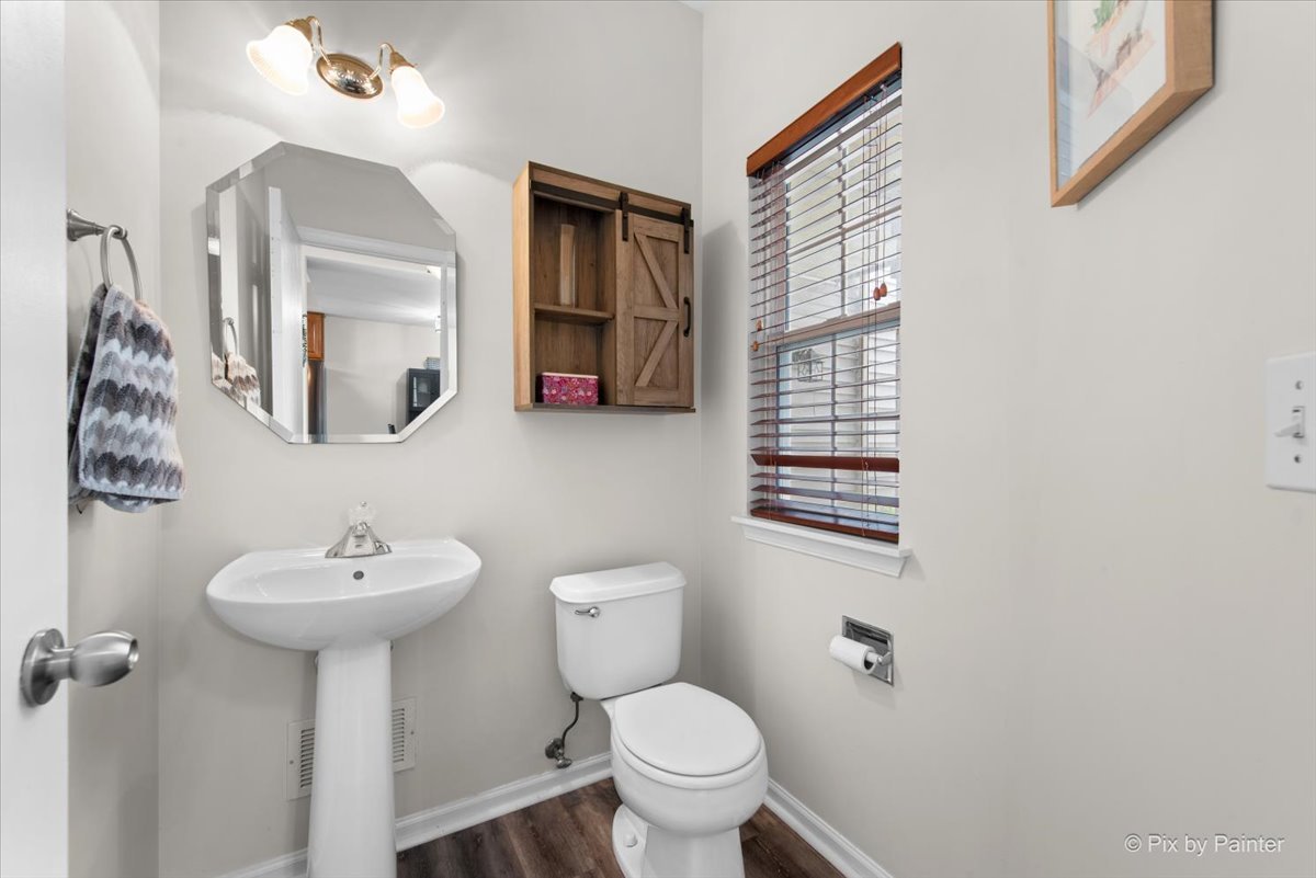 1033 Key Largo Drive Romeoville, IL 60446 - Photo 4 of 30 a bathroom with a toilet sink and mirror
