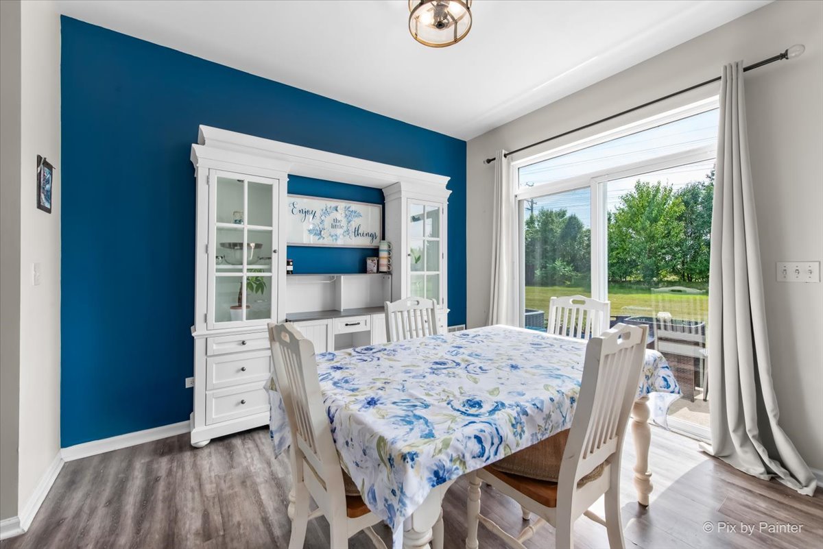 1033 Key Largo Drive Romeoville, IL 60446 - Photo 9 of 30 a view of a dining room with furniture window and wooden floor