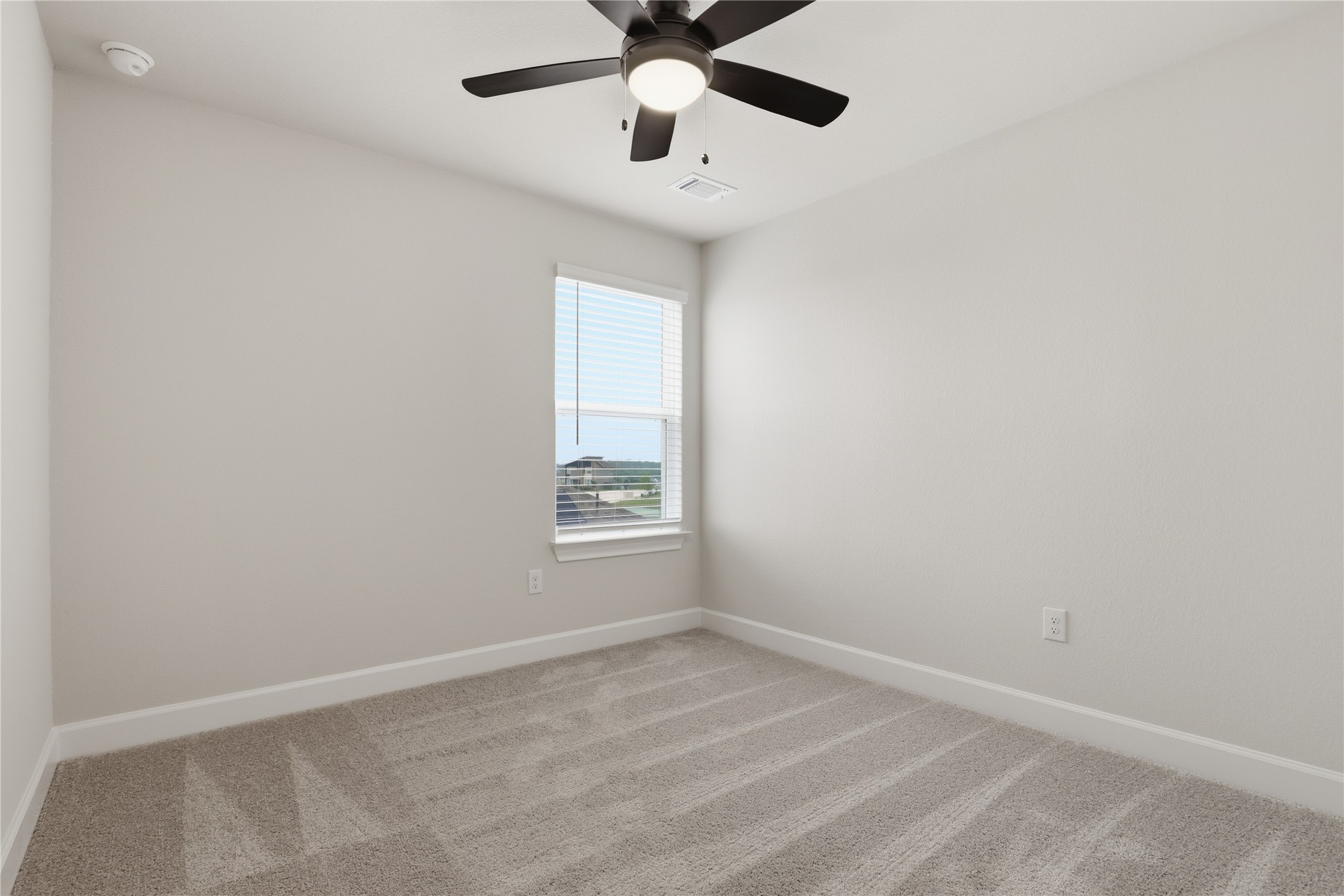 9320 Gladsome Path Manor, TX 78653 - Photo 19 of 34 an empty room with a window and a fan