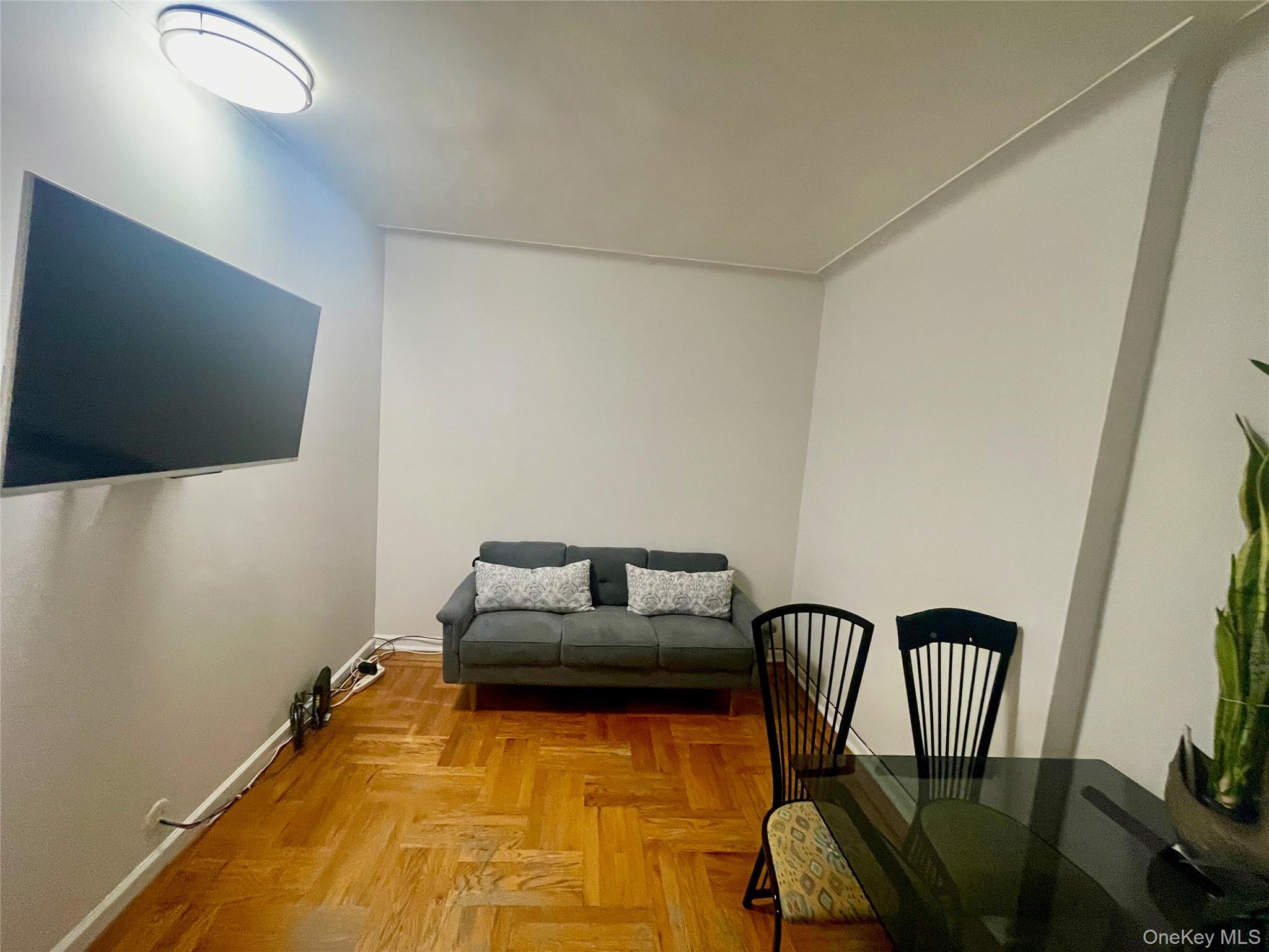 62-64 Saunders Street, Unit 1A Queens, NY 11374 - Photo 13 of 20 a living room with furniture and a flat screen tv