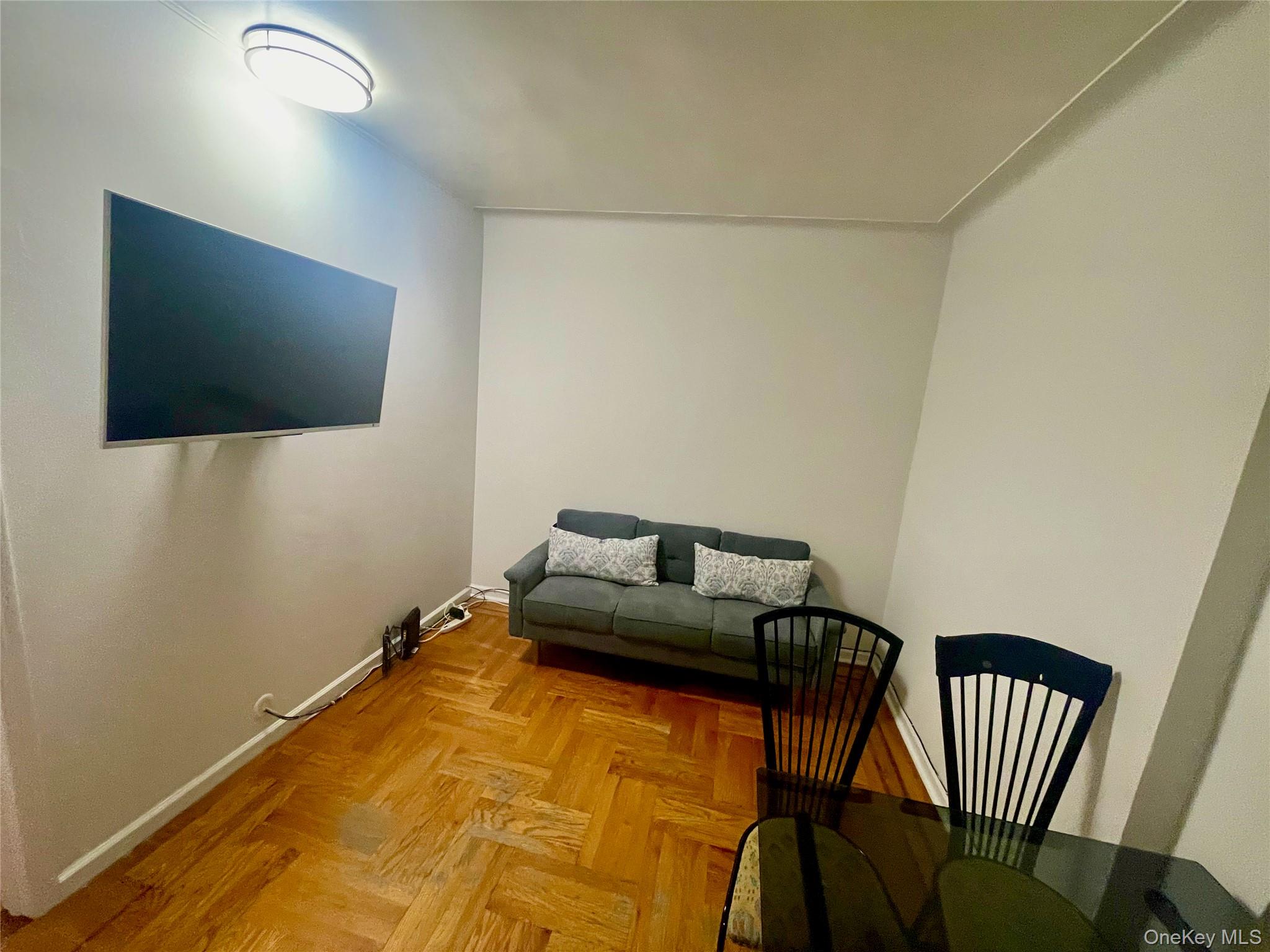 62-64 Saunders Street, Unit 1A Queens, NY 11374 - Photo 14 of 20 a bedroom with a bed and a flat screen tv