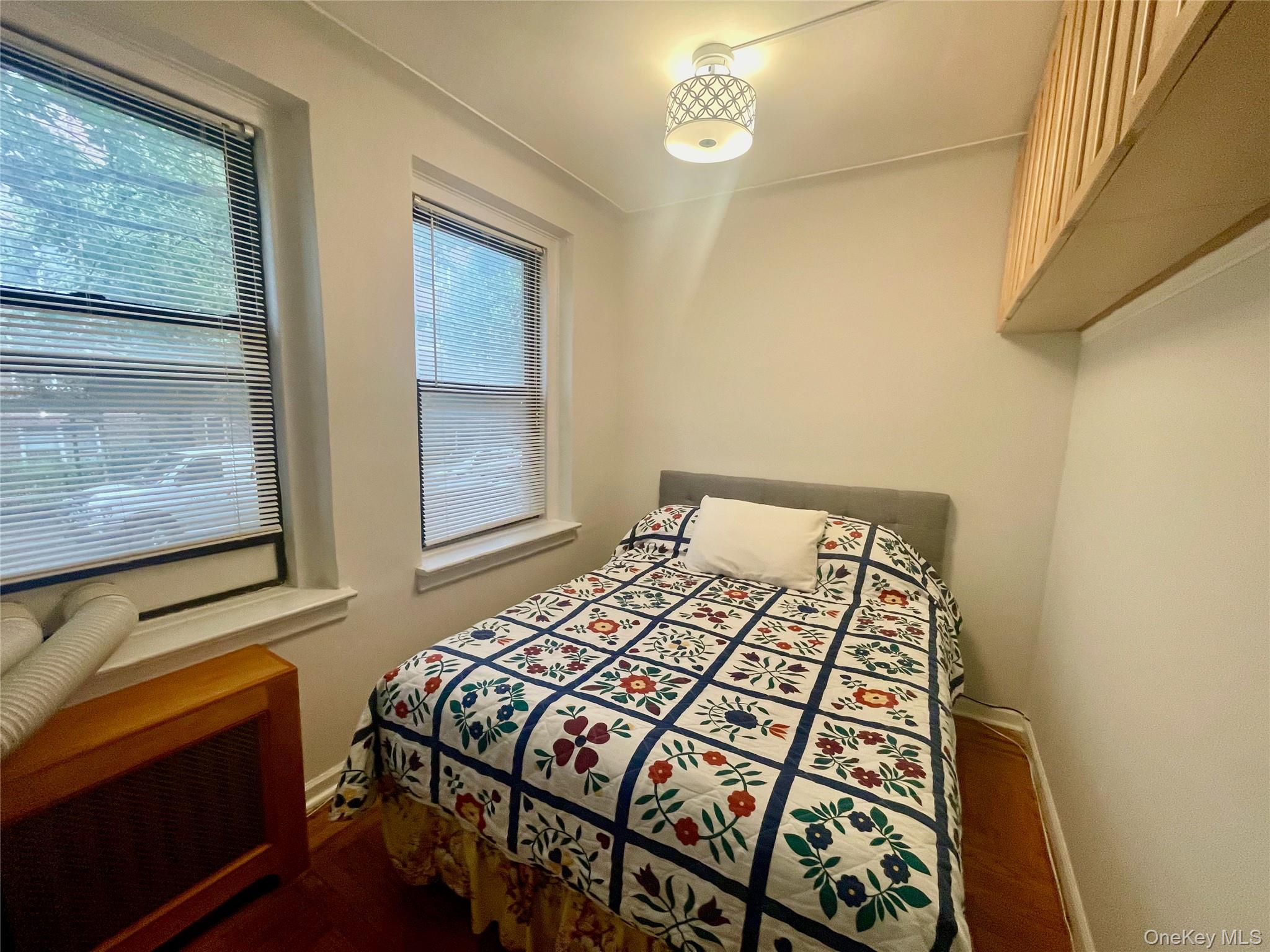 62-64 Saunders Street, Unit 1A Queens, NY 11374 - Photo 3 of 20 a bedroom with a bed and window