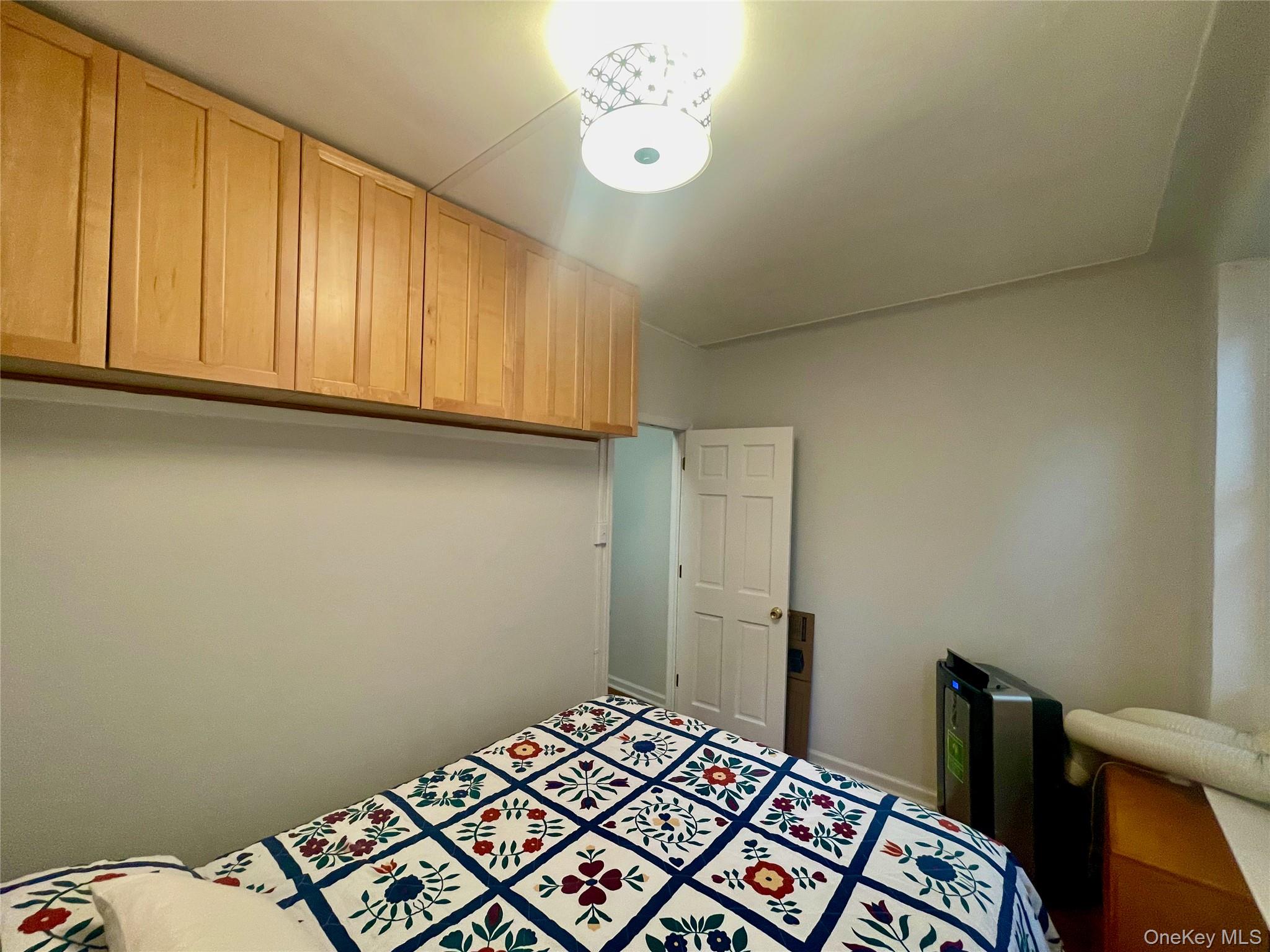 62-64 Saunders Street, Unit 1A Queens, NY 11374 - Photo 4 of 20 a bedroom with a bed and cabinets