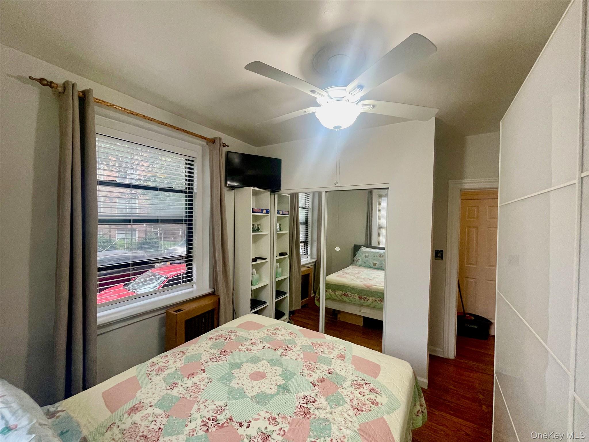62-64 Saunders Street, Unit 1A Queens, NY 11374 - Photo 7 of 20 a bedroom with a bed and wooden floor