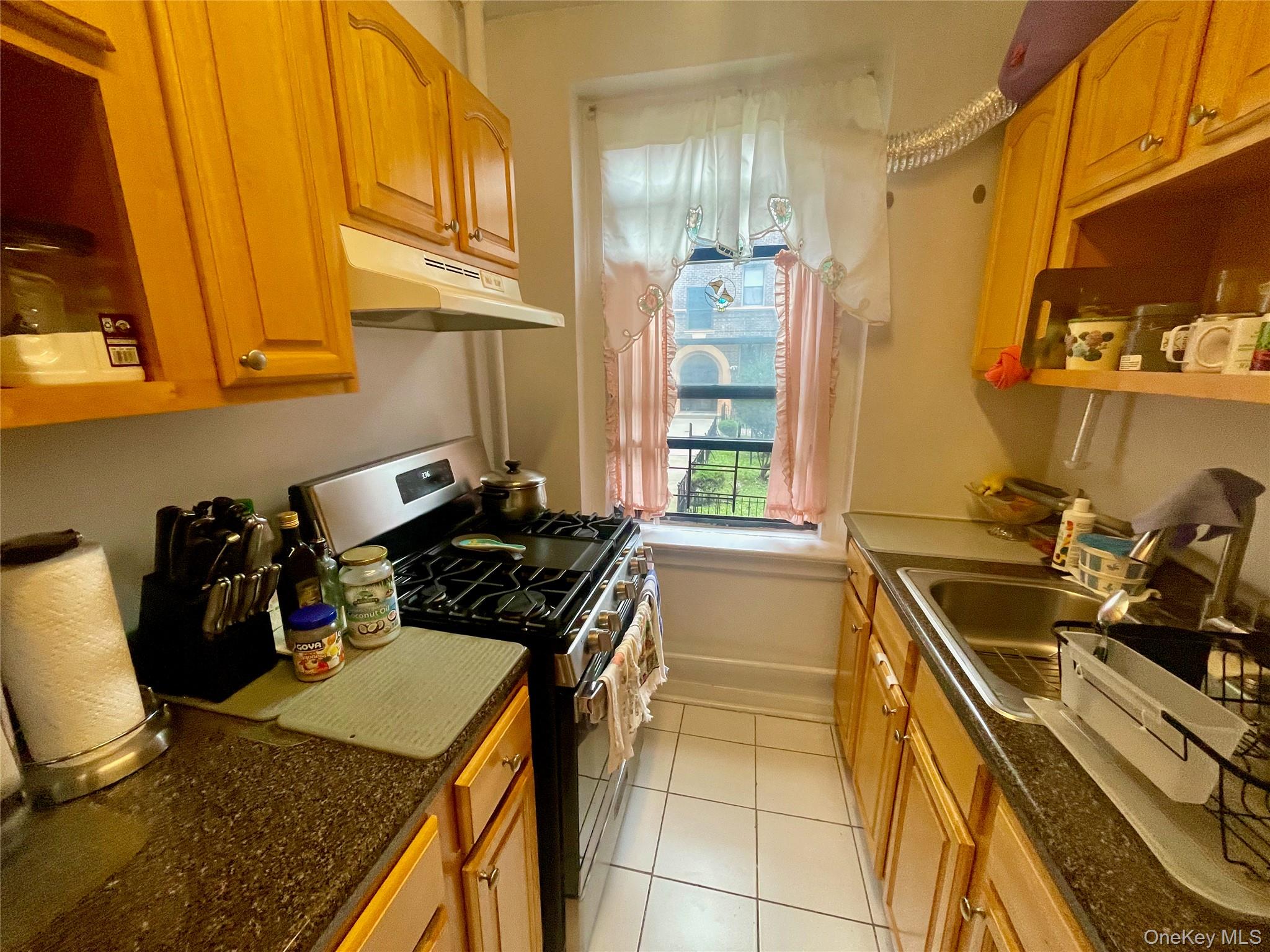 62-64 Saunders Street, Unit 1A Queens, NY 11374 - Photo 9 of 20 a kitchen with a sink a stove and cabinets