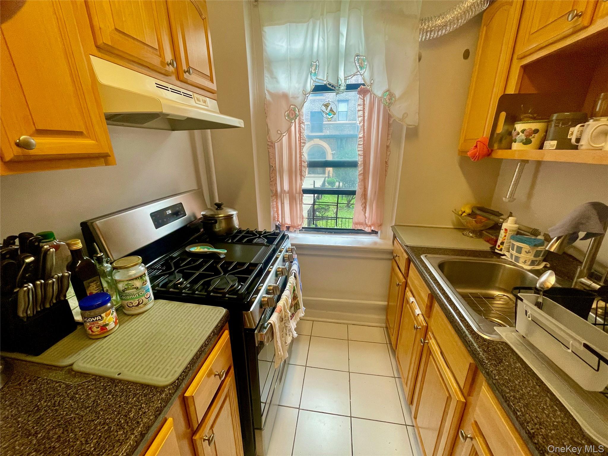 62-64 Saunders Street, Unit 1A Queens, NY 11374 - Photo 10 of 20 a kitchen with a sink a stove and cabinets
