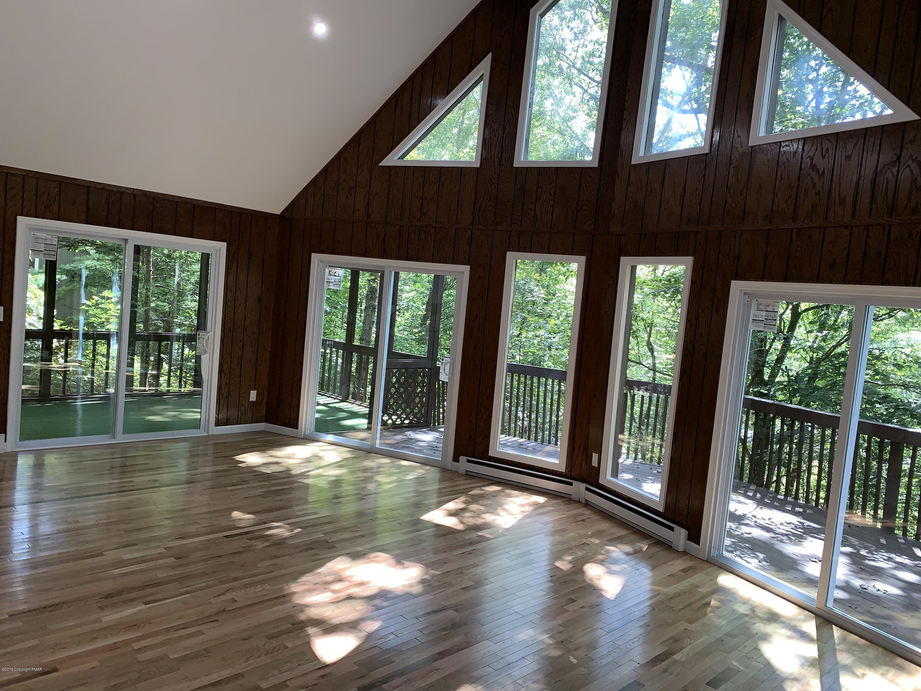 125 Edinburgh Road Bushkill, PA 18324 - Photo 3 of 19 a view of backyard with large trees and wooden fence