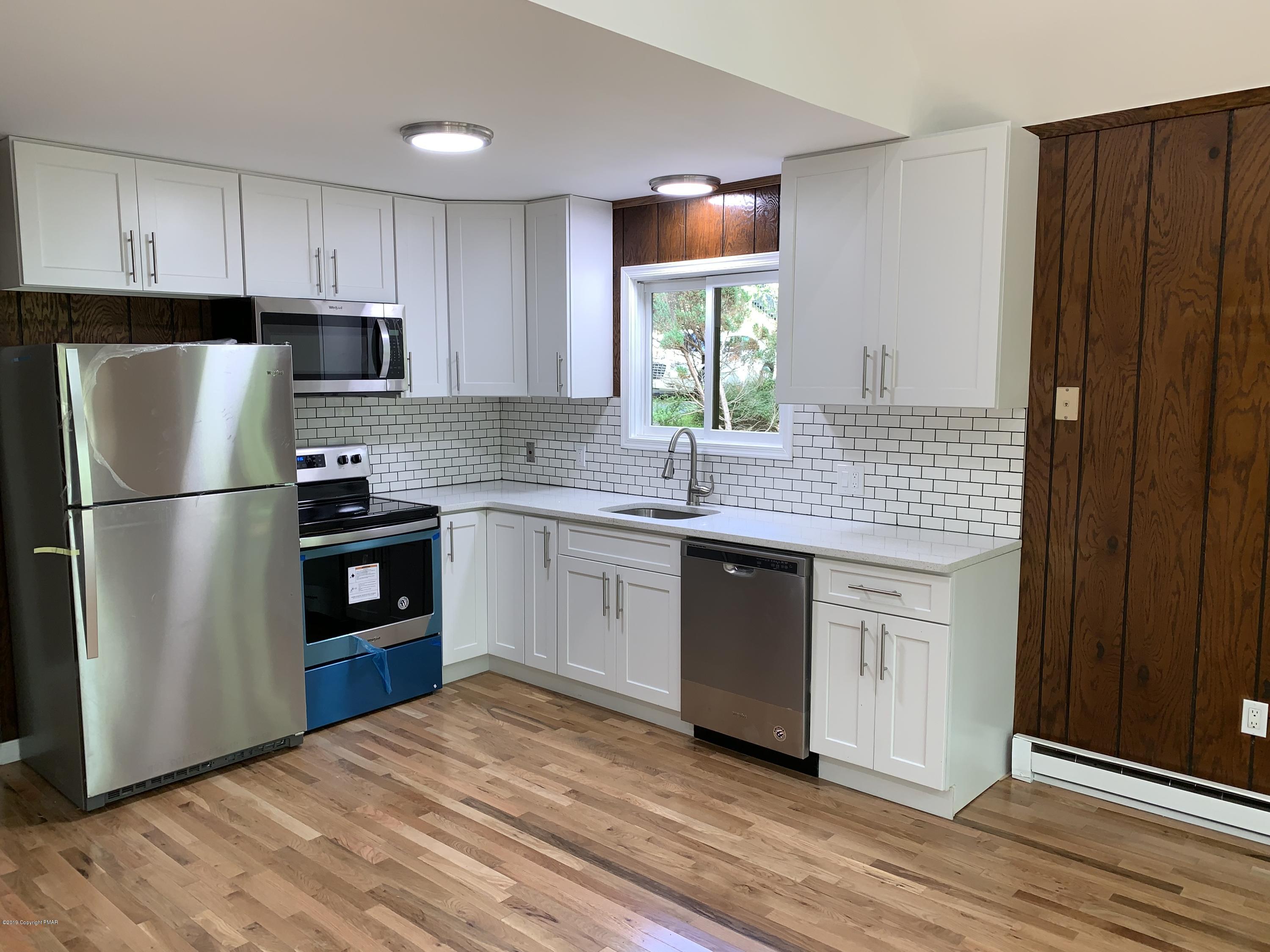 125 Edinburgh Road Bushkill, PA 18324 - Photo 5 of 19 a kitchen with stainless steel appliances granite countertop a refrigerator sink and cabinets