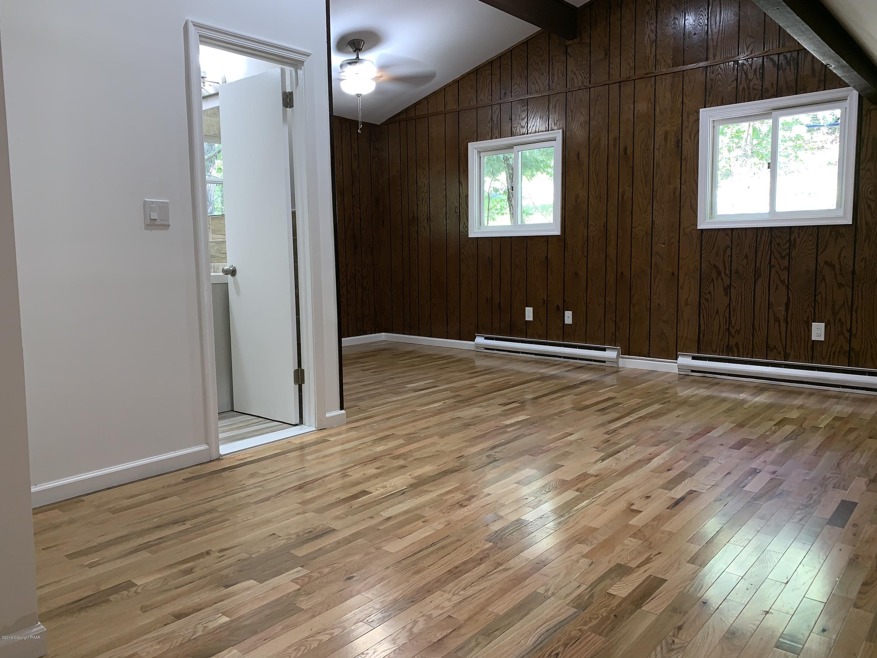 125 Edinburgh Road Bushkill, PA 18324 - Photo 9 of 19 an empty room with wooden floor and windows