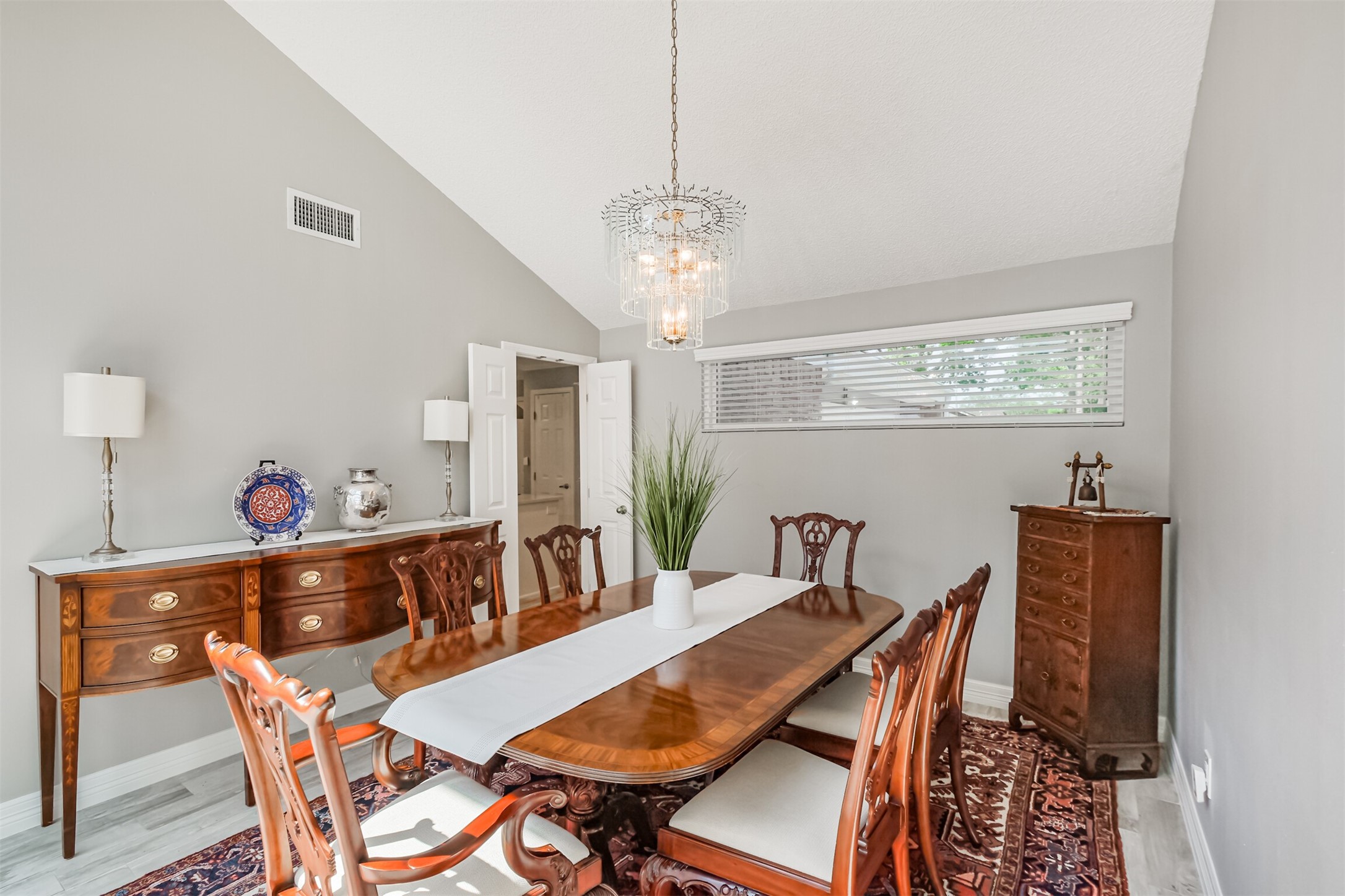 1007 Arrow Hill Road Houston, TX 77077 - Photo 9 of 48 The dining room has high ceilings and beautiful chandelier. You can access the kitchen through the white french doors.