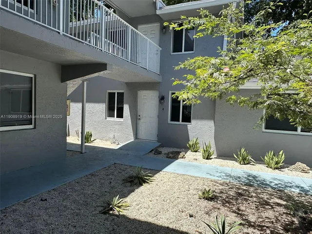 a front view of a house with trees