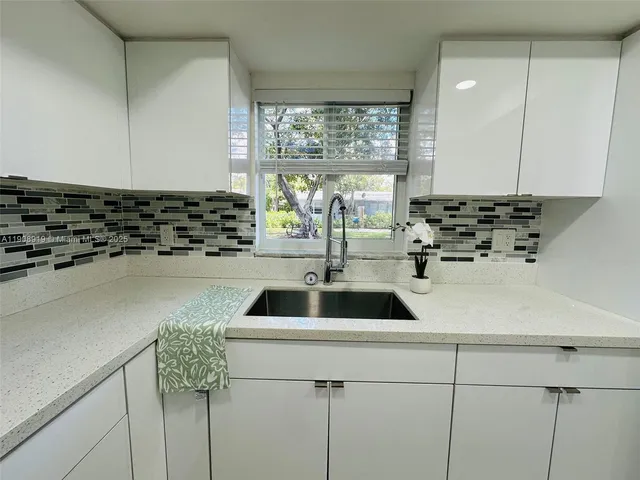 a kitchen with a sink and a stove