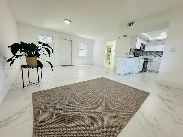 a view of a kitchen with sink and natural light