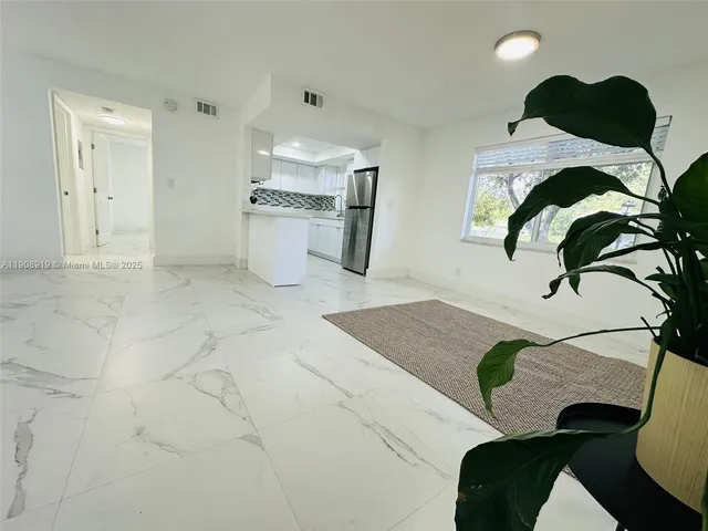 a view of kitchen with furniture and stainless steel appliances