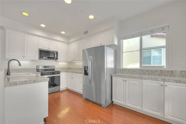 an empty room with a window and a ceiling fan