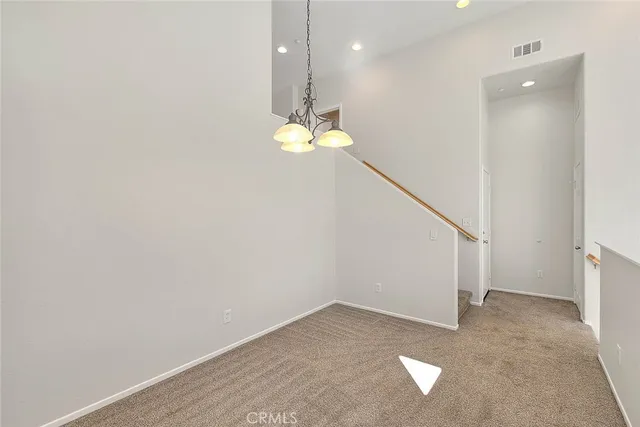 a kitchen with stainless steel appliances granite countertop a sink a microwave oven a refrigerator with white cabinets and wooden floor