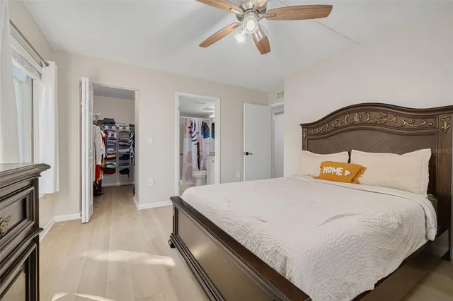 a bedroom with a bed and wooden floor