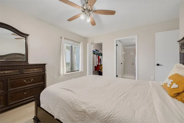 a bedroom with a large bed and a window