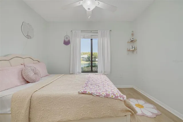 a bedroom with a large bed and a chandelier