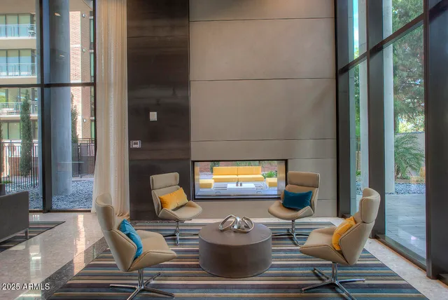 a living room with large pool and furniture