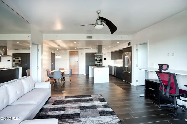 a living room with furniture and large windows