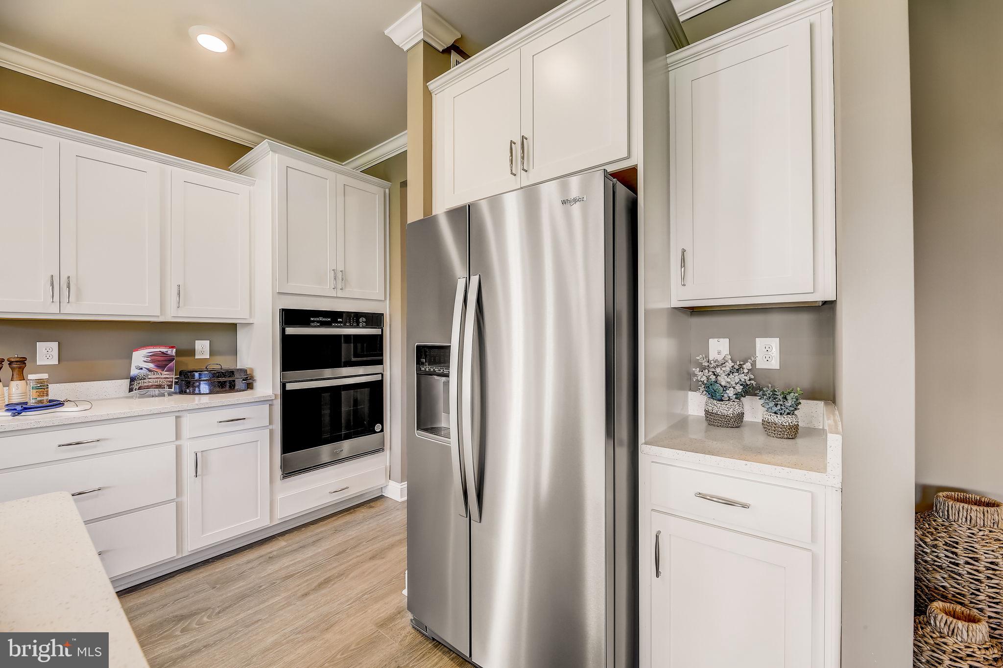 28 Country Living Road Elkton, MD 21921 - Photo 15 of 48 a kitchen with white cabinets and stainless steel appliances