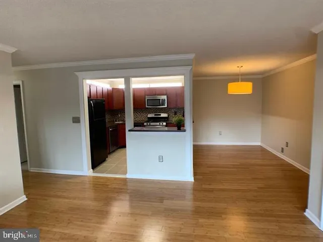 a view of a kitchen cabinets and wooden floor