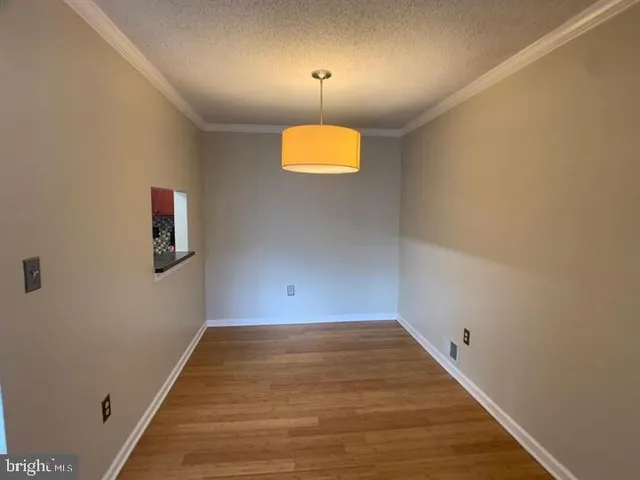 a view of a room with wooden floor and window