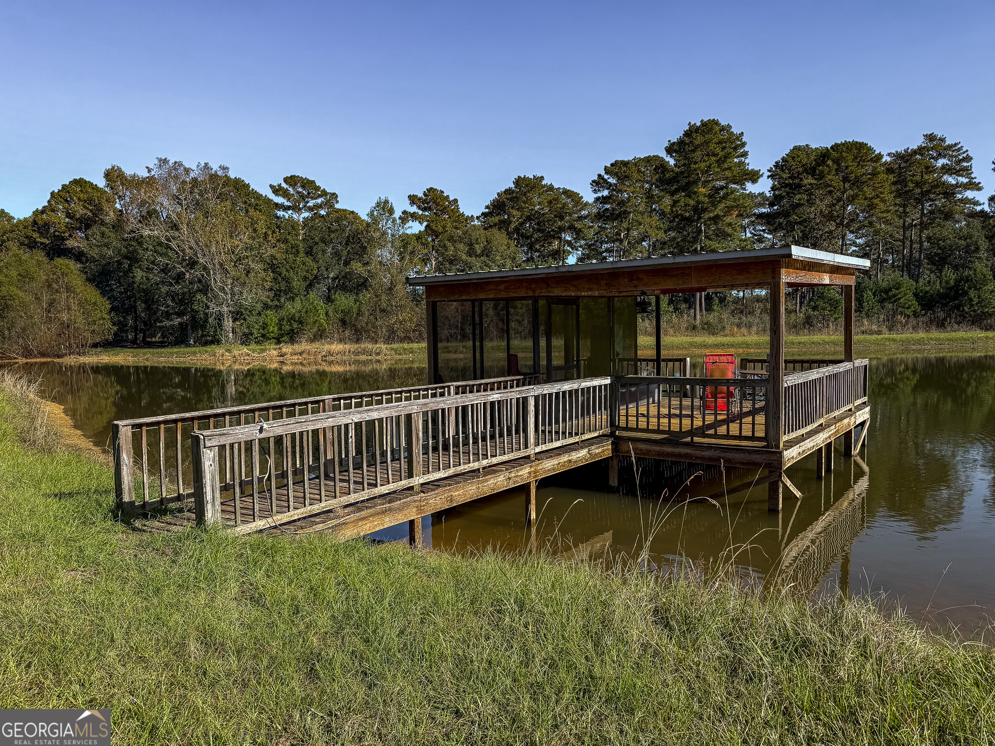 0 New York Road Leesburg, GA 31763 - Photo 17 of 19 a view of a wooden deck with a bench in a lake