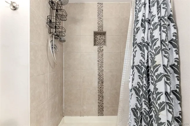a bathroom with a shower curtain and a shower curtain