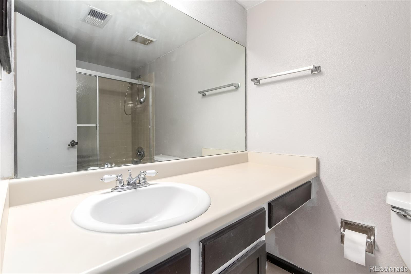 401 South Kalispell Way, Unit 104 Aurora, CO 80017 - Photo 20 of 29 a bathroom with a sink and a mirror