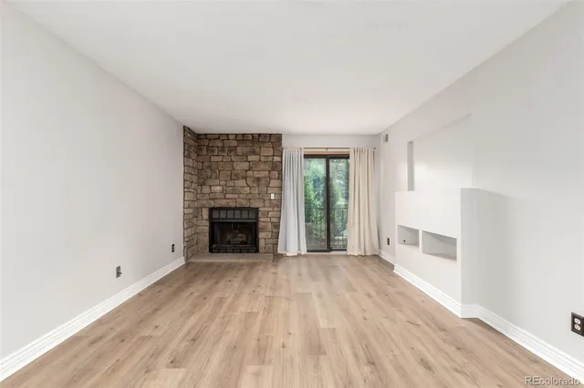 wooden floor fireplace and windows in a room