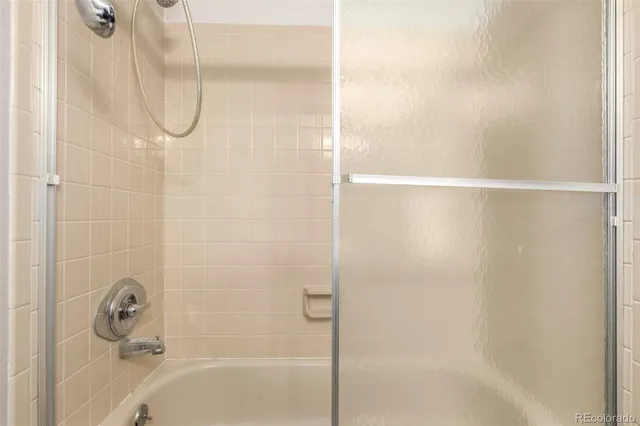 a bathroom with a glass shower door