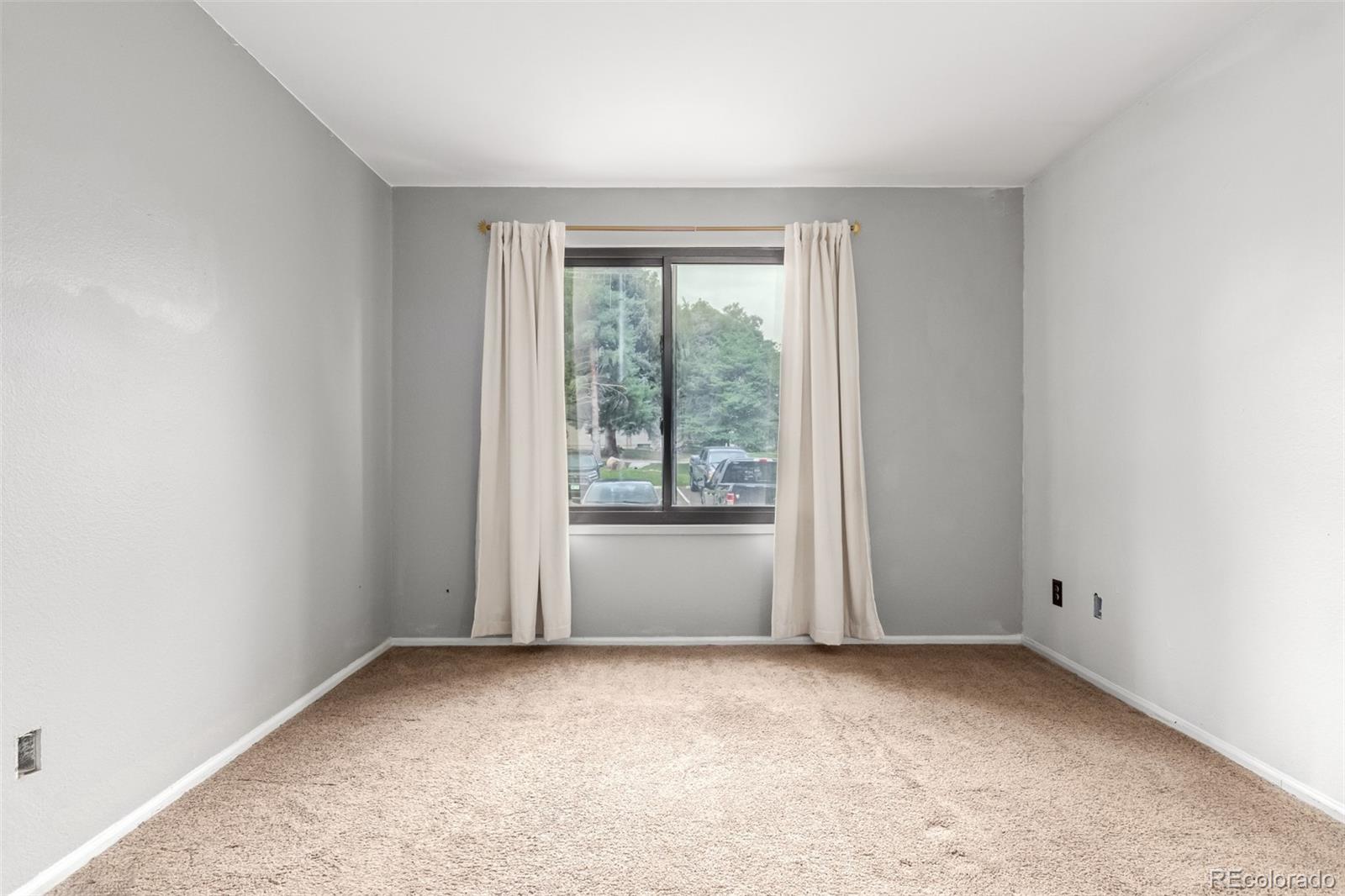 401 South Kalispell Way, Unit 104 Aurora, CO 80017 - Photo 22 of 29 an empty room with windows