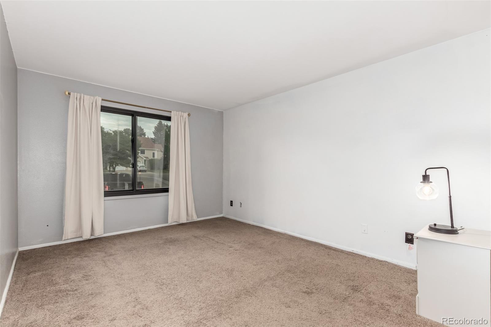 401 South Kalispell Way, Unit 104 Aurora, CO 80017 - Photo 10 of 29 a view of an empty room with a window