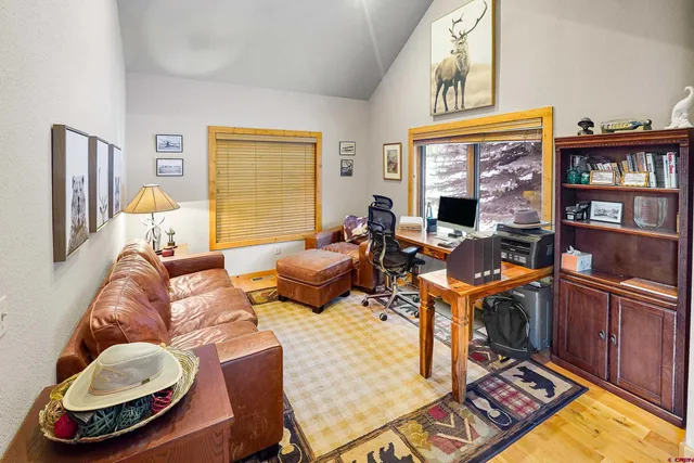 a living room with furniture a window and a flat screen tv