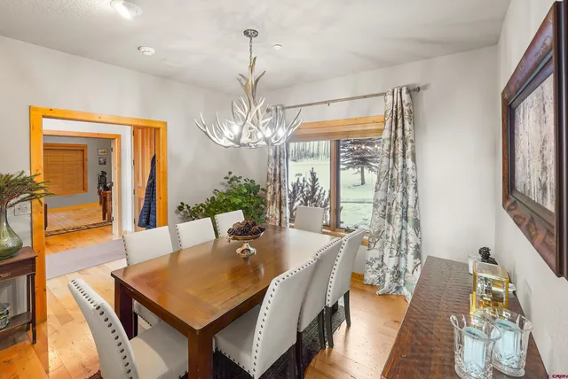 a view of a dining room with furniture and a chandelier