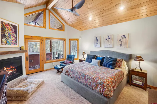 a bedroom with a bed a couch and a fireplace