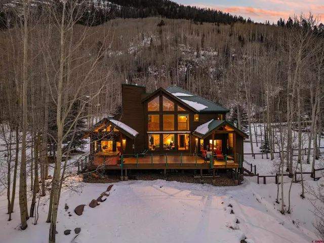 a view of house with outdoor space and wooden fence