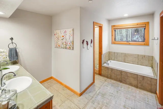 a bathroom with a sink a bathtub and a shower