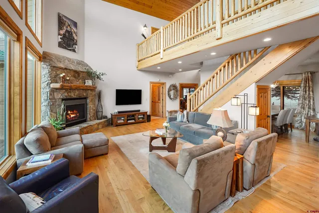 a living room with furniture fireplace and flat screen tv