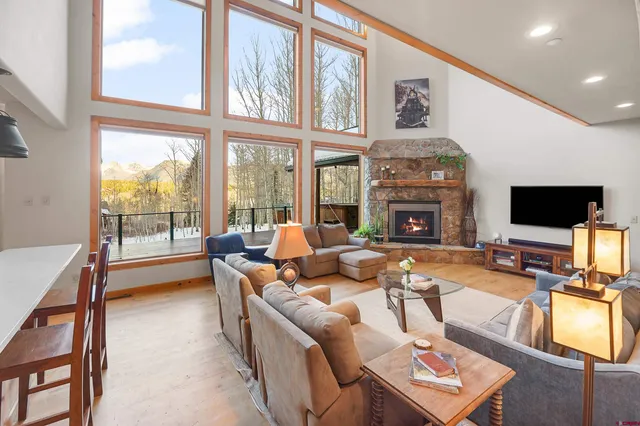 a living room with fireplace furniture and a flat screen tv