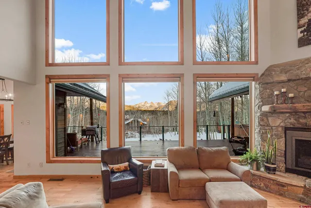 a living room with furniture and a floor to ceiling window