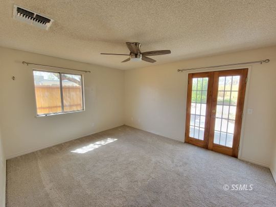 724 Ginger Avenue Ridgecrest, CA 93555 - Photo 15 of 21 an empty room with windows and fan