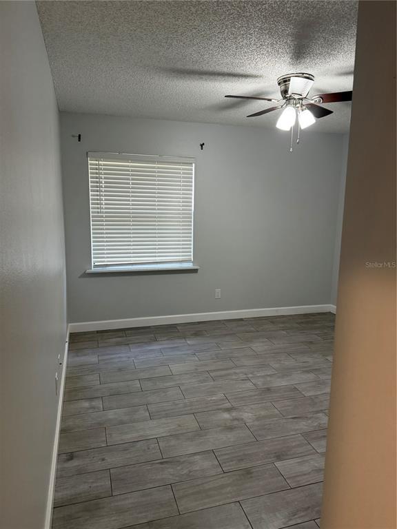 2701 Northeast 10th Street, Unit 802 Ocala, FL 34470 - Photo 5 of 16 a view of a livingroom with a ceiling fan and window