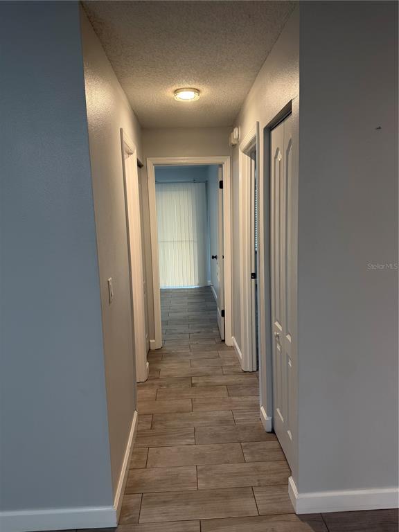 2701 Northeast 10th Street, Unit 802 Ocala, FL 34470 - Photo 8 of 16 a view of a hallway with wooden shelves