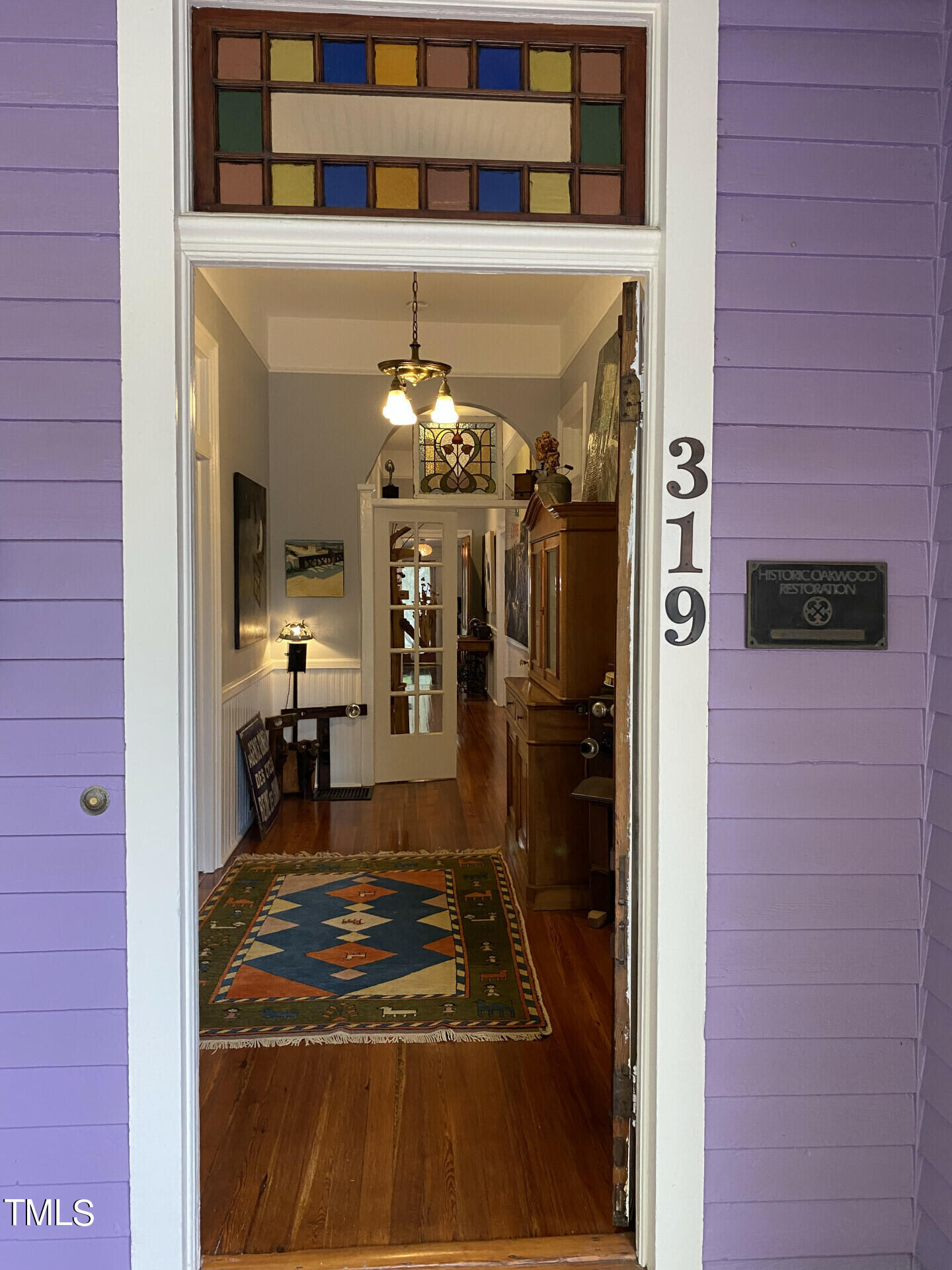 319 Polk Street Raleigh, NC 27604 - Photo 3 of 24 a room with glass door and furniture