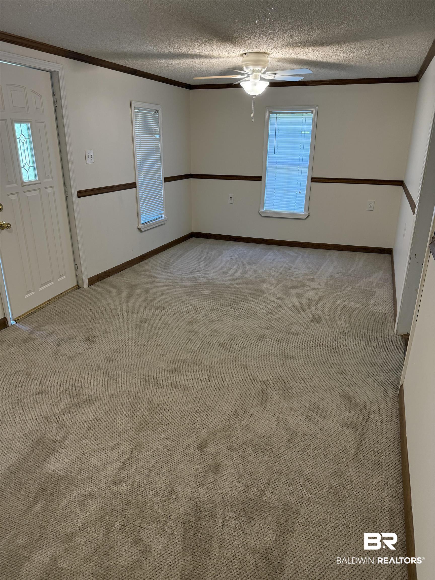 3630 Highway 29 Brewton, AL 36426 - Photo 6 of 13 Interior space featuring ceiling fan, a textured ceiling, and crown molding