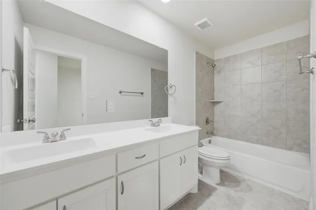 a bathroom with a sink a toilet and bathtub